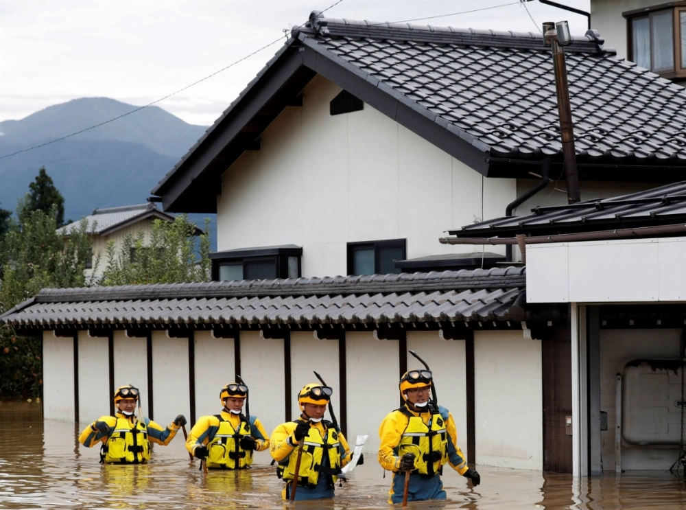 Rescue workers search a flooded area during the aftermath of Typhoon Hagibis, which caused severe floods at the Chikuma River, in the city of Nagano in October 2019. Rescue workers search a flooded area during the aftermath of Typhoon Hagibis, which caused severe floods at the Chikuma River, in the city of Nagano in October 2019.