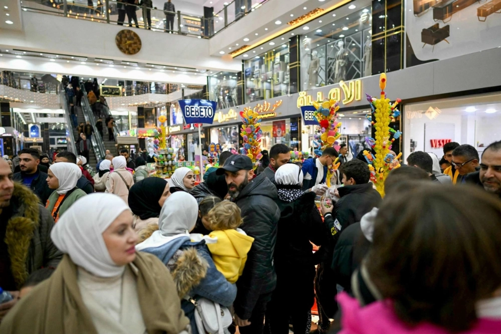 People shop at a mall in the town of al-Dana, near Sarmada, in the northern Syrian province of Idlib on Dec. 13. People shop at a mall in the town of al-Dana, near Sarmada, in the northern Syrian province of Idlib on Dec. 13.