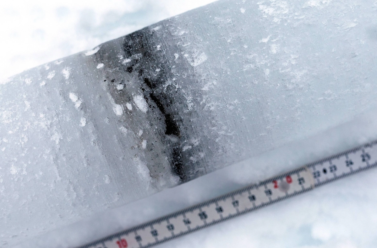 An ice core shows cryoconite layers made of a combination of bacteria, soot and small rock particles that build up on the snow and glaciers, near Ny-Aalesund, Svalbard, Norway, on April 7, 2023.  An ice core shows cryoconite layers made of a combination of bacteria, soot and small rock particles that build up on the snow and glaciers, near Ny-Aalesund, Svalbard, Norway, on April 7, 2023.