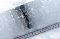 An ice core shows cryoconite layers made of a combination of bacteria, soot and small rock particles that build up on the snow and glaciers, near Ny-Aalesund, Svalbard, Norway, on April 7, 2023.  | REUTERS