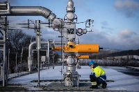 A worker inspects the outdoor gas pipes at the underground gas storage facility operated by Gas Storage in Haje, Czech Republic, on Jan. 3. | Bloomberg