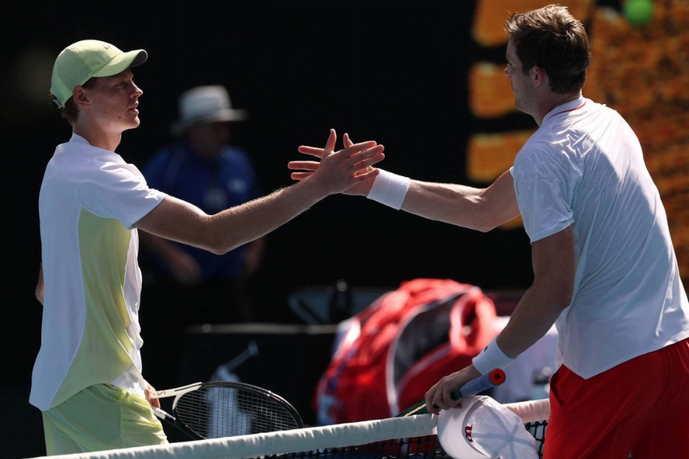 Jannik Sinner (left) and Nicolas Jarry meet at the net after their first-round match at the Australian Open in Melbourne on Monday. Sinner won 7-6 (7-2), 7-6 (7-5), 6-1. Jannik Sinner (left) and Nicolas Jarry meet at the net after their first-round match at the Australian Open in Melbourne on Monday. Sinner won 7-6 (7-2), 7-6 (7-5), 6-1.