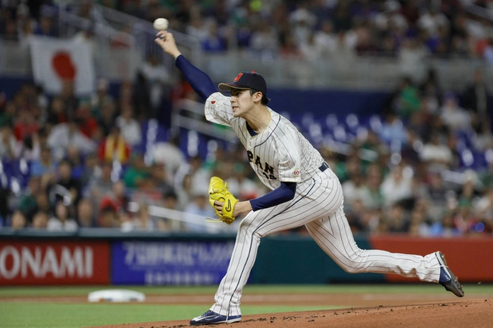 Japan starting pitcher Roki Sasaki delivers a pitch during the first inning of a World Baseball Classic semifinal game against Mexico in Miami in March 2023. Japan starting pitcher Roki Sasaki delivers a pitch during the first inning of a World Baseball Classic semifinal game against Mexico in Miami in March 2023.