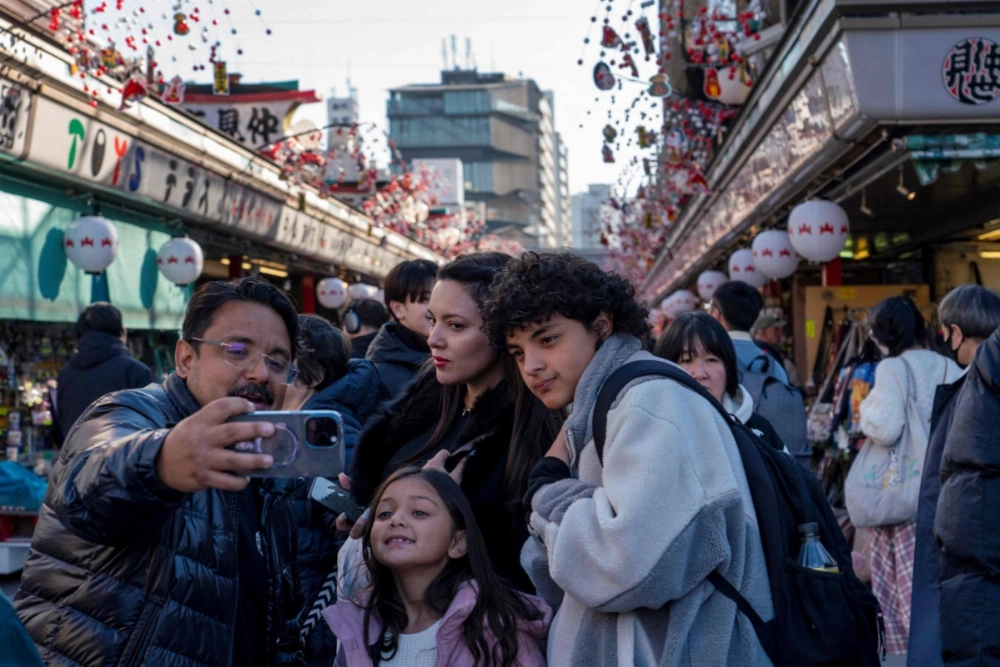 Tourists take photos at Sensoji temple in Tokyo's Asakusa district on Tuesday. Tourists take photos at Sensoji temple in Tokyo's Asakusa district on Tuesday.