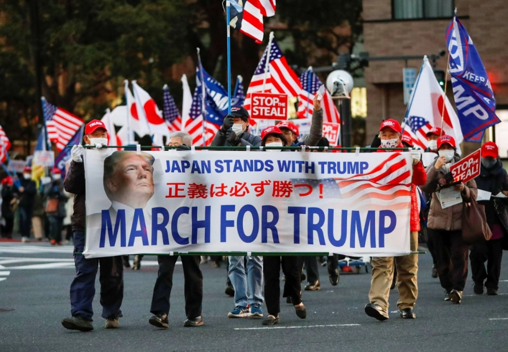 Supporters of U.S. President Donald Trump in Tokyo march ahead of the inauguration of then President-elect Joe Biden on Jan 20, 2021. Supporters of U.S. President Donald Trump in Tokyo march ahead of the inauguration of then President-elect Joe Biden on Jan 20, 2021.