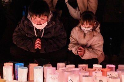 Children pray for the victims of the Great Hanshin-Awaji Earthquake during an early morning ceremony to mark the 30th anniversary of the quake, in Kobe on Friday. Children pray for the victims of the Great Hanshin-Awaji Earthquake during an early morning ceremony to mark the 30th anniversary of the quake, in Kobe on Friday.