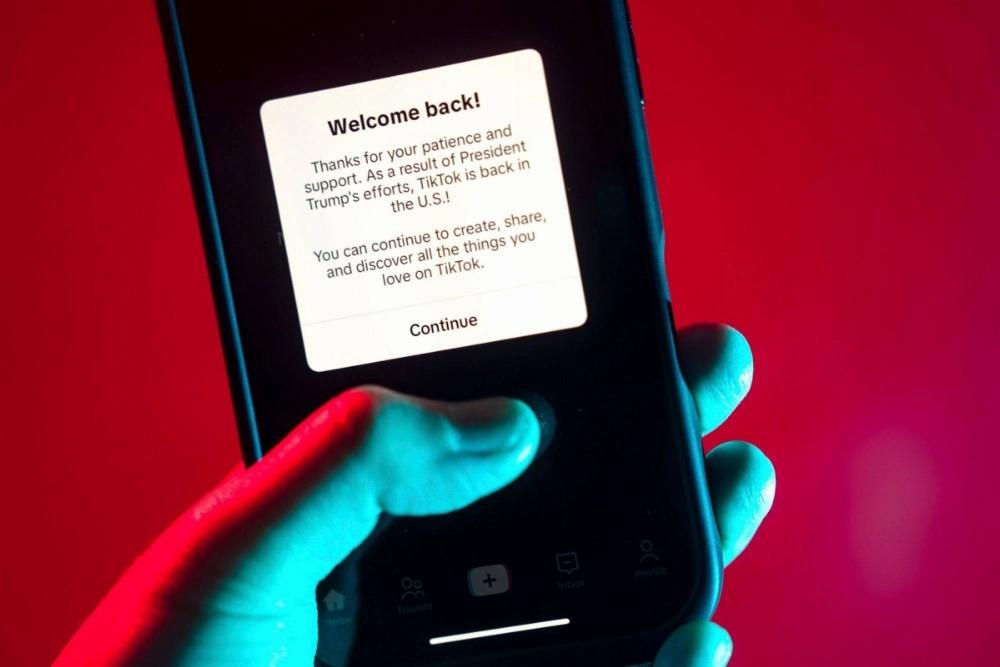 A message welcoming users back and thanking U.S. President-elect Donald Trump is displayed on the TikTok app on a smartphone Sunday.  A message welcoming users back and thanking U.S. President-elect Donald Trump is displayed on the TikTok app on a smartphone Sunday.