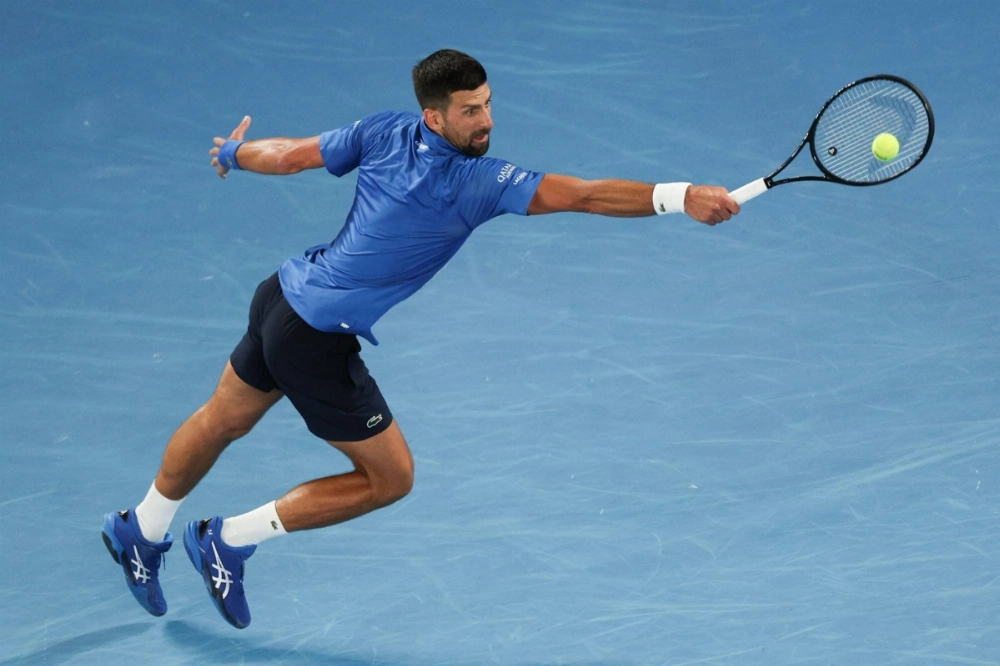 Serbia's Novak Djokovic hits a return against the Czech Republic's Jiri Lehecka during their men's singles match on Day 8 of the Australian Open tennis tournament in Melbourne on Sunday. Serbia's Novak Djokovic hits a return against the Czech Republic's Jiri Lehecka during their men's singles match on Day 8 of the Australian Open tennis tournament in Melbourne on Sunday.