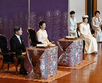 Emperor Naruhito, Empress Masako and Princess Aiko take part in the New Year's poetry reading ceremony at the Imperial Palace on Wednesday. | Pool / via Jiji