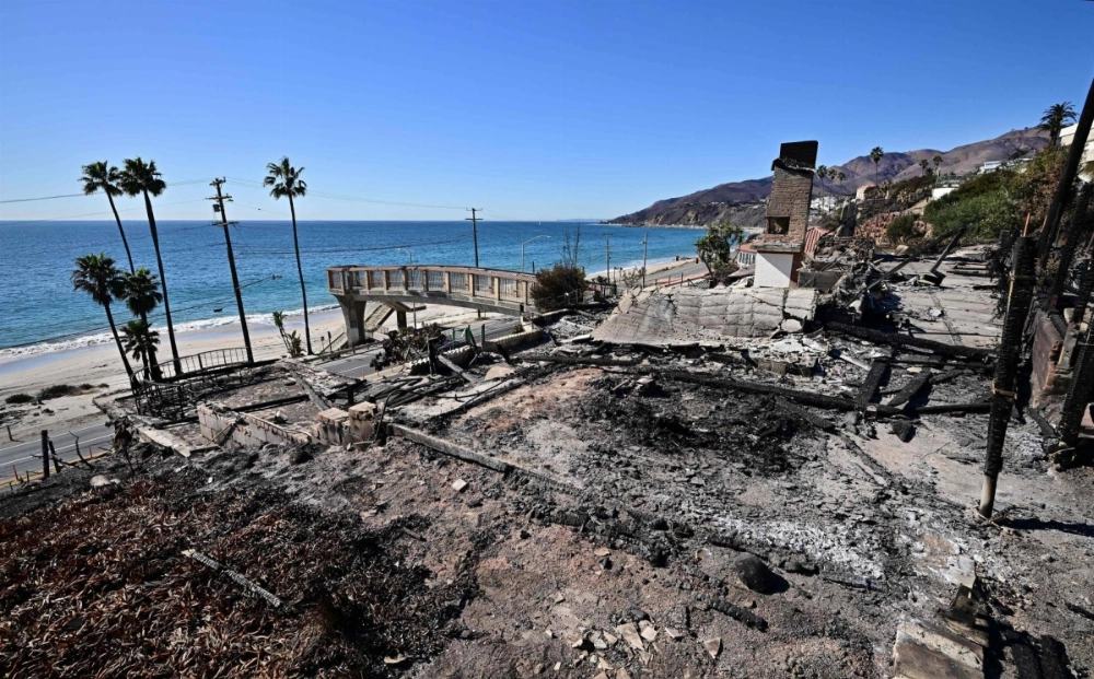 A charred chimney is all that remains at a fire-ravaged ocean front home in the Pacific Palisades neighborhood of Los Angeles on Jan. 16.  A charred chimney is all that remains at a fire-ravaged ocean front home in the Pacific Palisades neighborhood of Los Angeles on Jan. 16.