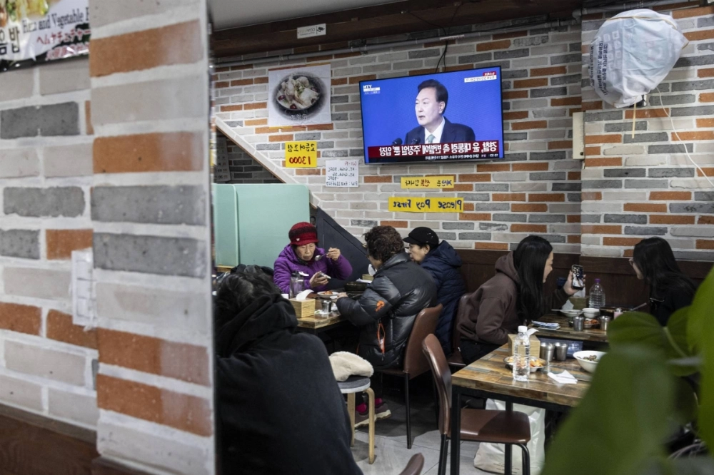 A television screen displays a news report on South Korean President Yoon Suk Yeol, inside a restaurant in Seoul on Dec. 28. 2024 A television screen displays a news report on South Korean President Yoon Suk Yeol, inside a restaurant in Seoul on Dec. 28. 2024