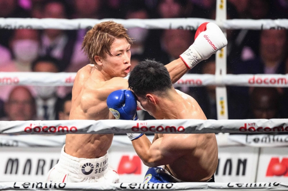 Naoya Inoue throws a punch against Kim Ye-joon during their world super bantamweight title bout in Tokyo on Friday.  Naoya Inoue throws a punch against Kim Ye-joon during their world super bantamweight title bout in Tokyo on Friday.
