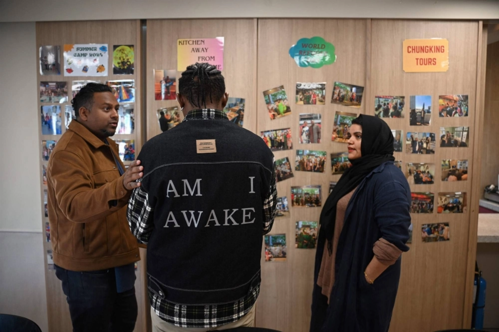Jeffrey Andrews (L), a social worker, and Uzma Naveed (R), an outreach coordinator, speak to "John" (C) at the Christian Action Center for Refugees in Hong Kong on Saturday. Jeffrey Andrews (L), a social worker, and Uzma Naveed (R), an outreach coordinator, speak to "John" (C) at the Christian Action Center for Refugees in Hong Kong on Saturday.