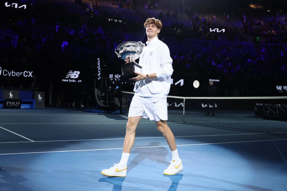 Italy's Jannik Sinner celebrates with the Australian Open trophy after winning a straight-sets final over Alexander Zverev on Sunday in Melbourne.  Italy's Jannik Sinner celebrates with the Australian Open trophy after winning a straight-sets final over Alexander Zverev on Sunday in Melbourne.
