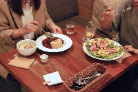 Two friends catch up over lunch at Choice Kyoto, a long-standing vegan cafe serving Western-style dishes in Gion, the city’s ancient entertainment district. | Sachi Kitajima Mulkey / Grist