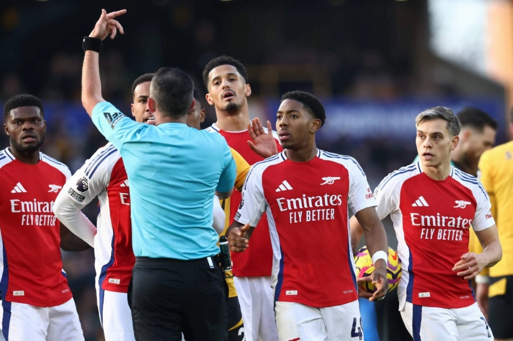 Arsenal midfielder Myles Lewis-Skelly (second right) reacts after being sent off by referee Michael Oliver on January 25, 2025. Arsenal midfielder Myles Lewis-Skelly (second right) reacts after being sent off by referee Michael Oliver on January 25, 2025.