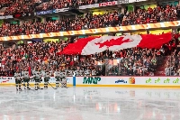 A Canadian flag is displayed in the stands during the Canadian national anthem prior to the start of a game between the Senators and the Wild in Ottawa on Saturday. | Imagn Images / VIA REUTERS