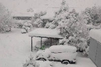 A car is buried under snow in a residential parking lot in the city of Toyama on Wednesday. | Alexander Howell-Jackson