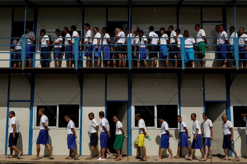 Drug rehab patients walk in formation to have lunch at the Mega Drug Abuse Treatment and Rehabilitation Center, north of Manila, in 2019.  Drug rehab patients walk in formation to have lunch at the Mega Drug Abuse Treatment and Rehabilitation Center, north of Manila, in 2019.