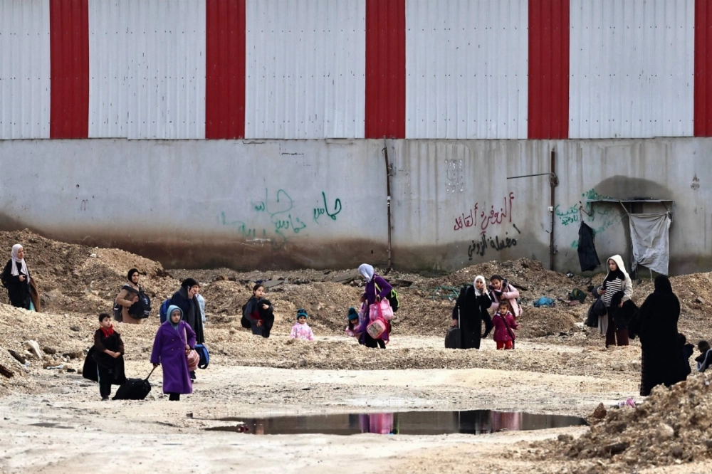 Palestinians leave their homes for safety during a raid by the Israeli army in the Nur Shams refugee camp near Tulkarem in the occupied West Bank on Monday. Palestinians leave their homes for safety during a raid by the Israeli army in the Nur Shams refugee camp near Tulkarem in the occupied West Bank on Monday.