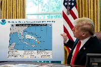 President Donald Trump shows a National Oceanic and Atmospheric Administration (NOAA) forecast track of Hurricane Dorian that was altered with a black marker in Washington on Sept. 4, 2019. | Erin Schaff / The New York Times