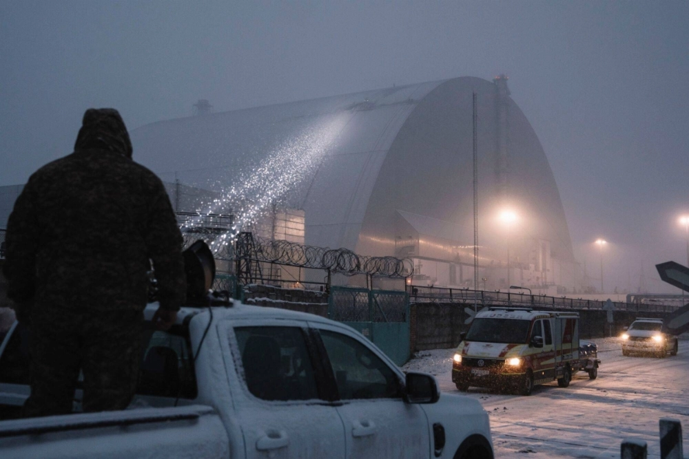 A Ukrainian serviceman watches an inspection of damage to the radiation containment shield of Reactor 4 at the Chernobyl nuclear power plant following a Russian drone strike in Chernobyl, Ukraine, on Friday. A Ukrainian serviceman watches an inspection of damage to the radiation containment shield of Reactor 4 at the Chernobyl nuclear power plant following a Russian drone strike in Chernobyl, Ukraine, on Friday.