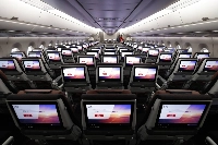 In-flight entertainment screens on the economy class seats of an Airbus SE A350-1000 aircraft operated by Japan Airlines at the company's hangar at Haneda Airport in January 2024. The airline is relying on new aircraft for half of its planned emissions cuts. | Bloomberg