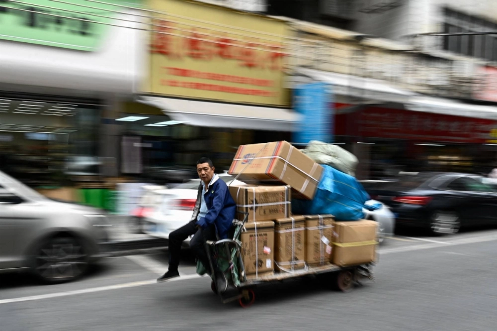 Goods are transported through a business district in Dongguan, in China’s southern Guangdong province. Goods are transported through a business district in Dongguan, in China’s southern Guangdong province.