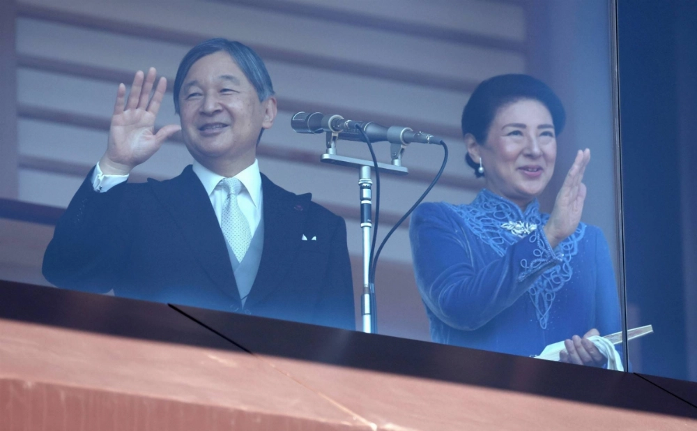 Emperor Naruhito and Empress Masako greet people gathered at the Imperial Palace in Tokyo on Sunday to celebrate the emperor's 65th birthday that day. Emperor Naruhito and Empress Masako greet people gathered at the Imperial Palace in Tokyo on Sunday to celebrate the emperor's 65th birthday that day.