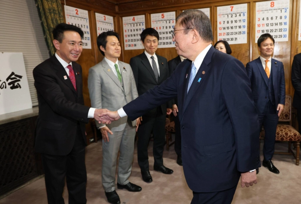 Nippon Ishin no Kai co-leader Seiji Maehara (left) greets Prime Minister Shigeru Ishiba after the budget was passed at the Lower House — with the support of the opposition party — on Tuesday. Nippon Ishin no Kai co-leader Seiji Maehara (left) greets Prime Minister Shigeru Ishiba after the budget was passed at the Lower House — with the support of the opposition party — on Tuesday.