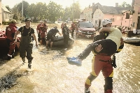 Emergency service personnel help evacuate residents from the flooded town of Lewin Brzeski, Poland, in September 2024.  | Bloomberg