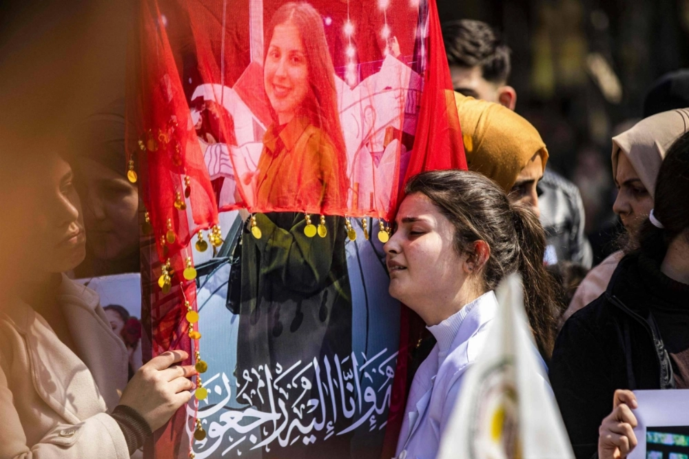 A woman reacts next to one of the pictures of victims of a recent wave of sectarian violence targeting Syria's Alawite minority in the west of the country along the Mediterranean sea coast, during a protest condemning the attacks in Syria's northeastern city of Qamishli on Tuesday. A woman reacts next to one of the pictures of victims of a recent wave of sectarian violence targeting Syria's Alawite minority in the west of the country along the Mediterranean sea coast, during a protest condemning the attacks in Syria's northeastern city of Qamishli on Tuesday.