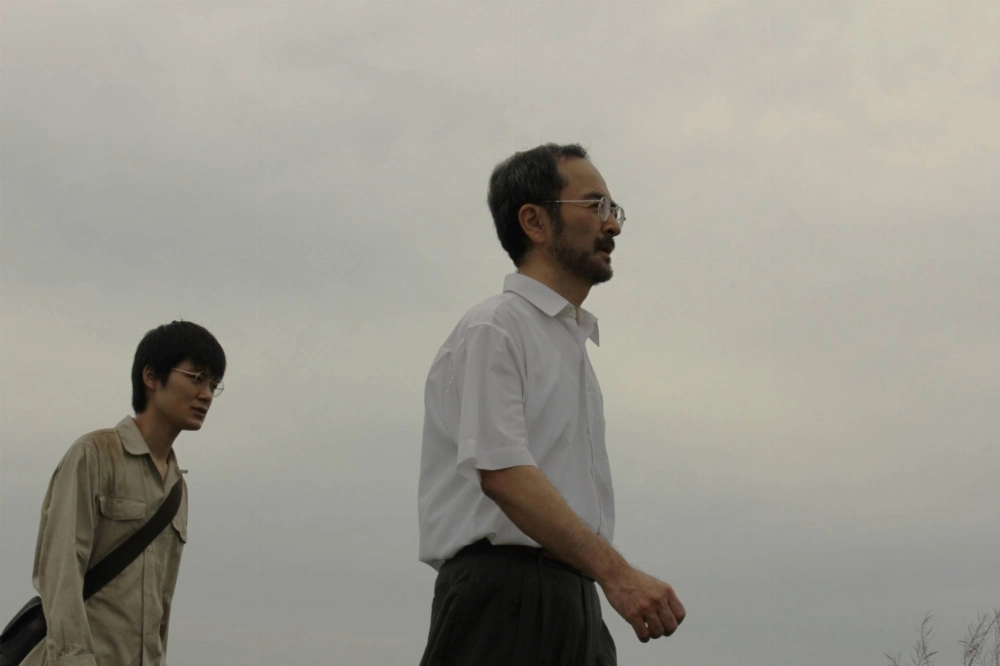 Masao Adachi’s “Escape” is a fictionalized biopic about fugitive Satoshi Kirishima, played by Rairu Sugita (left) and Kanji Furutachi (right). Masao Adachi’s “Escape” is a fictionalized biopic about fugitive Satoshi Kirishima, played by Rairu Sugita (left) and Kanji Furutachi (right).