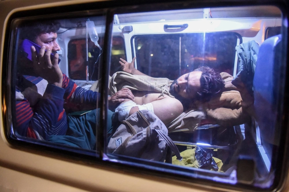 An injured train passenger is being transported following an operation against armed militants who ambushed the train in the remote mountainous area in Mach, southwestern Balochistan province in Pakistan on Wednesday. An injured train passenger is being transported following an operation against armed militants who ambushed the train in the remote mountainous area in Mach, southwestern Balochistan province in Pakistan on Wednesday.
