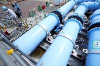 Blue pipelines to transport seawater, part of the facility operated by Tepco where treated radioactive water is released from the Fukushima No.1 nuclear power plant into the sea, are seen during a treated water dilution and discharge facility tour for foreign media in the town of Futaba, Fukushima Prefecture, in August 2023. | Pool / via Reuters