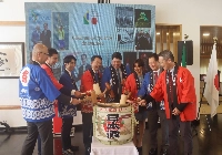 Participants perform Kagami Biraki (the opening of the sake barrel) at an event promoting this year's World Exposition held at the Japanese Embassy in Brasilia on Wednesday. | Jiji