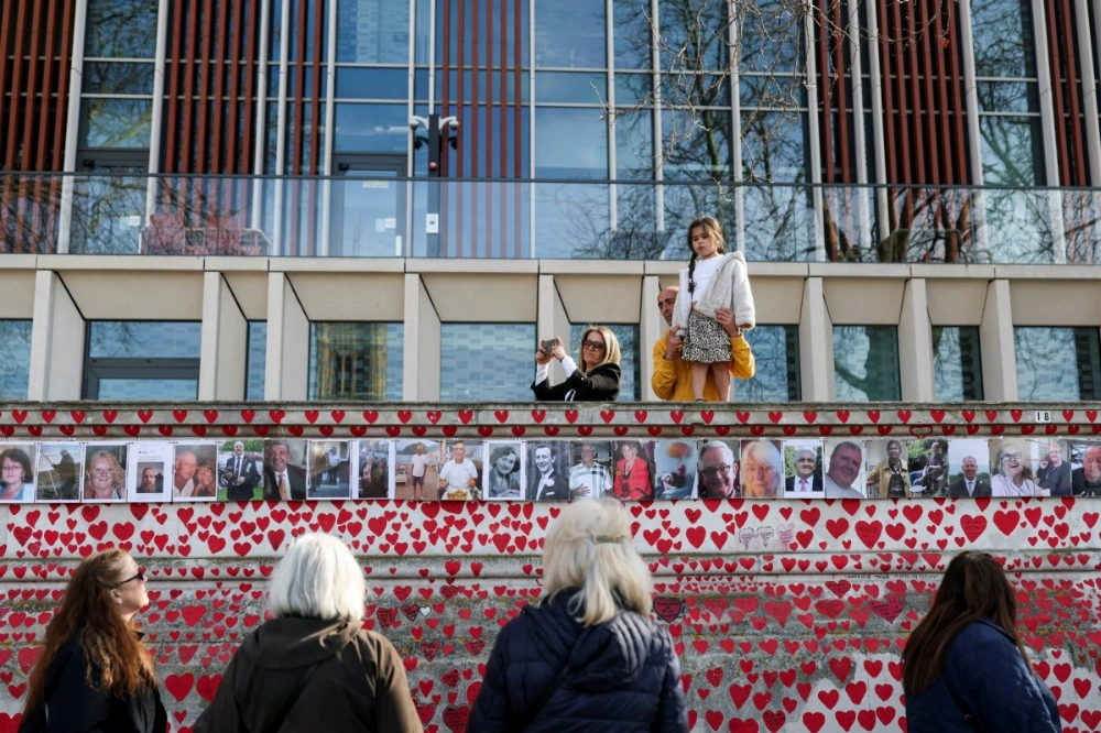 People gather at the National Covid Memorial Wall on the COVID-19 Day of Reflection, marking 5 years since the start of the pandemic, in London on March 9. People gather at the National Covid Memorial Wall on the COVID-19 Day of Reflection, marking 5 years since the start of the pandemic, in London on March 9.