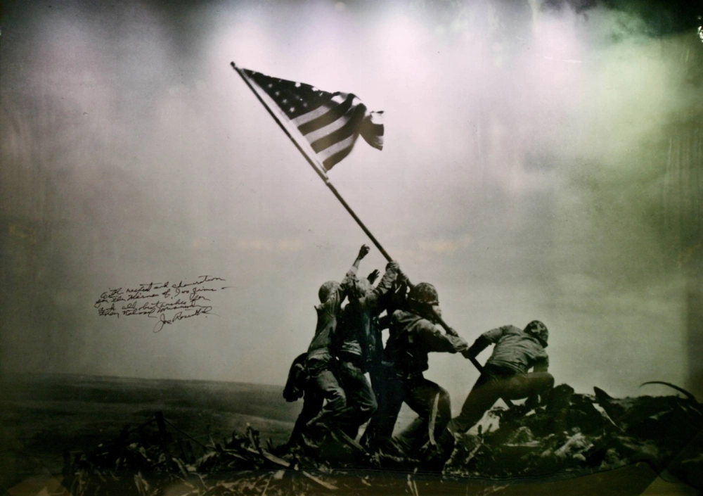 A signed picture by photographer Joe Rosenthal of U.S. Marines raising the American flag on Iwo Jima is shown as part of a display at the new National Museum of the Marine Corps in Quantico, Virginia, in November 2006. A signed picture by photographer Joe Rosenthal of U.S. Marines raising the American flag on Iwo Jima is shown as part of a display at the new National Museum of the Marine Corps in Quantico, Virginia, in November 2006.