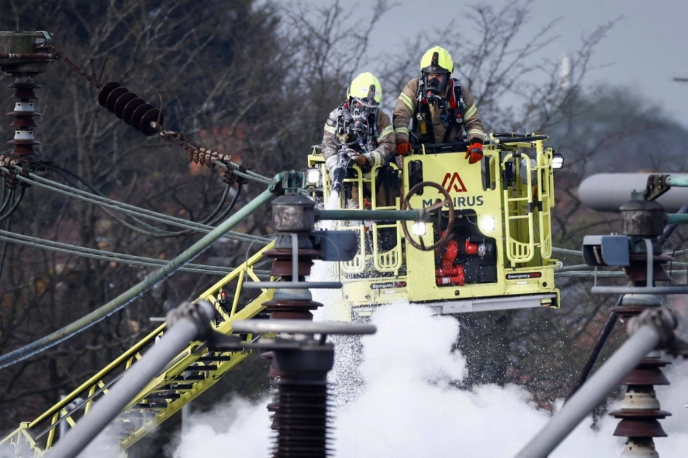 Firefighters douse the flames of a fire that broke out at a substation supplying power to Heathrow Airport in Hayes, England, on Friday.  Firefighters douse the flames of a fire that broke out at a substation supplying power to Heathrow Airport in Hayes, England, on Friday.
