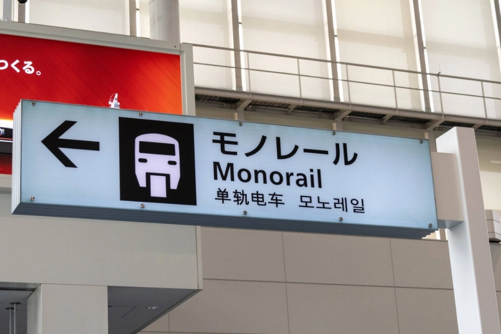 A sign at Tokyo's Haneda Airport shows users the way to the monorail in four different languages.  A sign at Tokyo's Haneda Airport shows users the way to the monorail in four different languages.