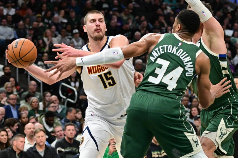 Denver Nuggets' Serbian center Nikola Jokic (left) looks to pass the ball away from Milwaukee Bucks' Greek forward Giannis Antetokounmpo in the third quarter at Fiserv Forum, Milwaukee on Feb 27.  Denver Nuggets' Serbian center Nikola Jokic (left) looks to pass the ball away from Milwaukee Bucks' Greek forward Giannis Antetokounmpo in the third quarter at Fiserv Forum, Milwaukee on Feb 27.