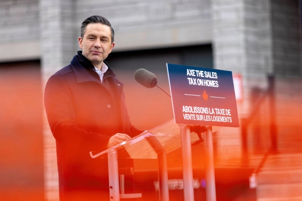 Conservative Party of Canada leader Pierre Poilievre, seen behind orange construction fencing, speaks at an election campaign event Ontario, Canada, on Tuesday.  Conservative Party of Canada leader Pierre Poilievre, seen behind orange construction fencing, speaks at an election campaign event Ontario, Canada, on Tuesday.