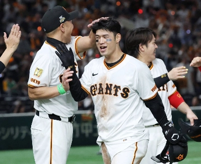 The Giants' Gakuto Wakabayashi (right) celebrates with Giants manager Shinnosuke Abe after his game-winning hit against the Swallows at Tokyo Dome on Friday. The Giants' Gakuto Wakabayashi (right) celebrates with Giants manager Shinnosuke Abe after his game-winning hit against the Swallows at Tokyo Dome on Friday.