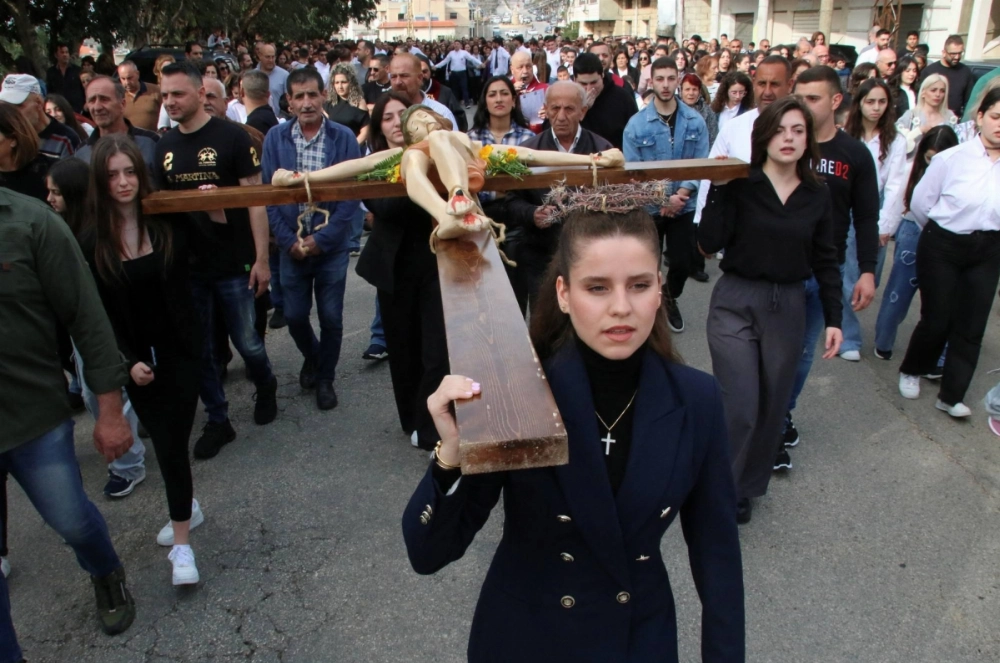 Christian worshippers take part in a Good Friday procession as they carry a cross with a Jesus statue in the town of Klayaa, in southern Lebanon, on March 29, 2024. Christian worshippers take part in a Good Friday procession as they carry a cross with a Jesus statue in the town of Klayaa, in southern Lebanon, on March 29, 2024.