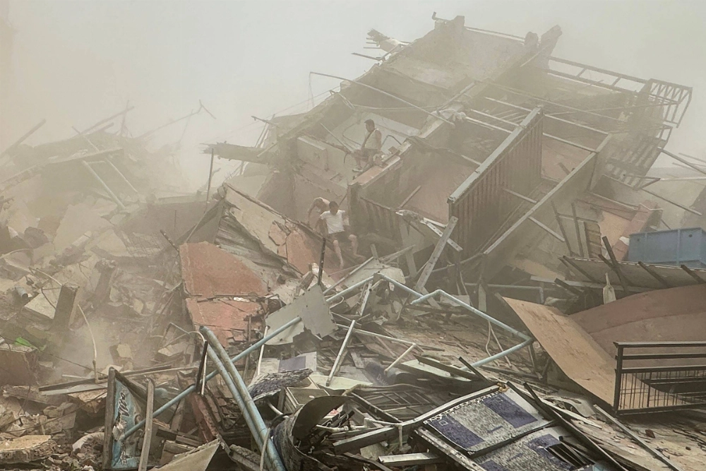 People inspect the debris of a collapsed building in Mandalay, Myanmar, on Friday after an earthquake. People inspect the debris of a collapsed building in Mandalay, Myanmar, on Friday after an earthquake.