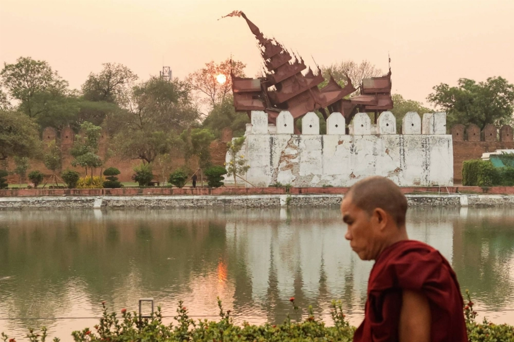 A Buddhist monk walks past the damaged Mandalay Palace on Monday. The country's ruling military junta can repeat the mistakes of 17 years ago by blocking aid after Cyclone Nargis left 140,000 dead or allow urgent assistance to flow freely.
  A Buddhist monk walks past the damaged Mandalay Palace on Monday. The country's ruling military junta can repeat the mistakes of 17 years ago by blocking aid after Cyclone Nargis left 140,000 dead or allow urgent assistance to flow freely.