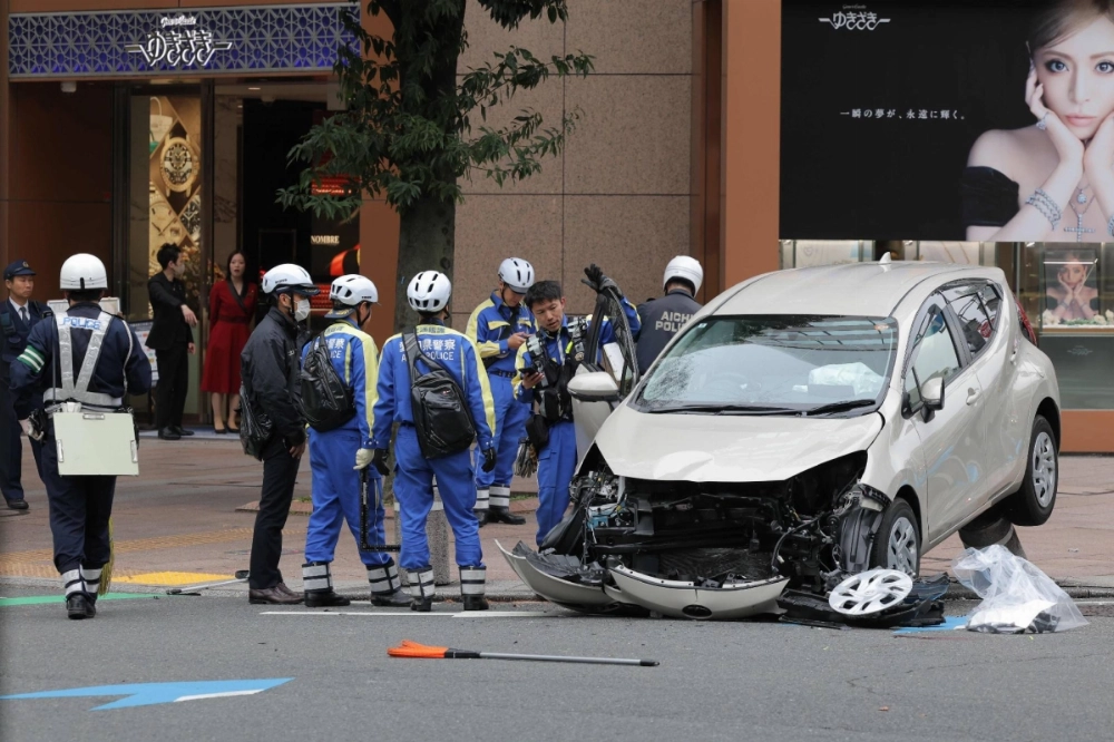 Aichi police investigate the scene of an accident where a passenger car barreled through a busy section of downtown Nagoya on Tuesday. Aichi police investigate the scene of an accident where a passenger car barreled through a busy section of downtown Nagoya on Tuesday.