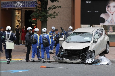 Aichi police investigate the scene of an accident where a passenger car barreled through a busy section of downtown Nagoya on Tuesday. Aichi police investigate the scene of an accident where a passenger car barreled through a busy section of downtown Nagoya on Tuesday.