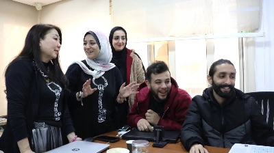 Rozan Al-Khazendar (second from left), an entrepreneur from the Gaza Strip, speaks to Kiyomi Kitamura (left), her Japanese partner in a T-shirt venture to raise funds for the Palestinian enclave, during a meeting at her office in the outskirts of Cairo, last December. Rozan Al-Khazendar (second from left), an entrepreneur from the Gaza Strip, speaks to Kiyomi Kitamura (left), her Japanese partner in a T-shirt venture to raise funds for the Palestinian enclave, during a meeting at her office in the outskirts of Cairo, last December.