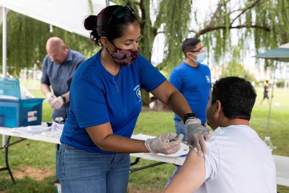 A doctor administers COVID-19 vaccinations to members of the Latino community in Bensalem, Pennsylvania, in August 2021. A doctor administers COVID-19 vaccinations to members of the Latino community in Bensalem, Pennsylvania, in August 2021.
